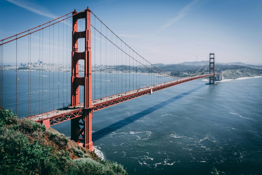 Iconic Golden Gate Bridge over San Francisco Bay under clear blue skies, showcasing its majestic structure.